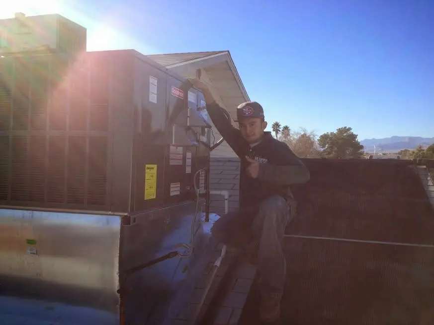 HVAC technician performing HVAC Inspection on a rooftop unit in Haddon Heights